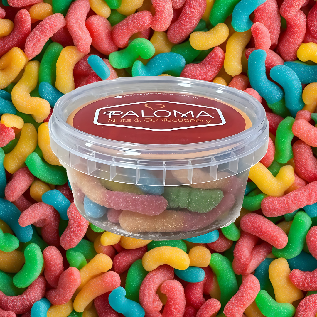 Clear plastic container of colorful gummy candies labeled ’Paloma Nuts & Confectionery’.